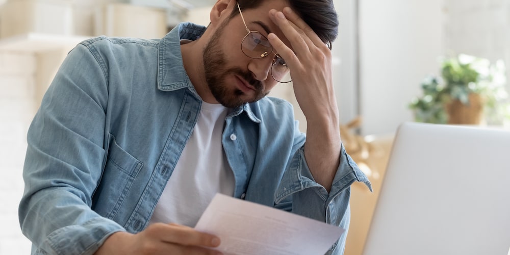Papers Man looking at bill